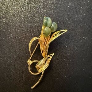 Vintage gold plated jade filagree floral brooch. 2 3/4” L x 1” W.